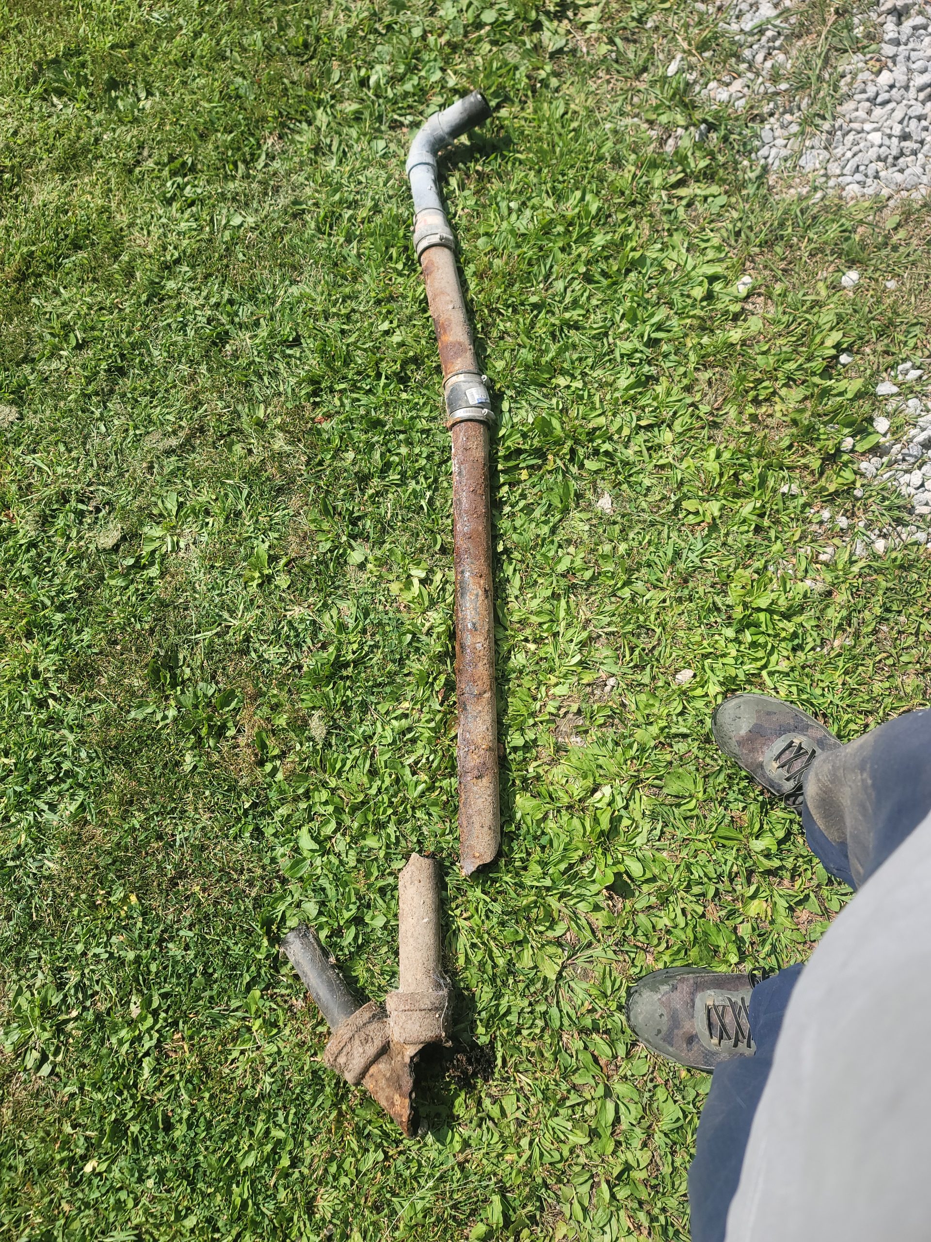 Old rusted galvanized sewer pipe with cast iron hub fitting, removed during sewer line replacement by Critical Plumbing in Greater Cleveland