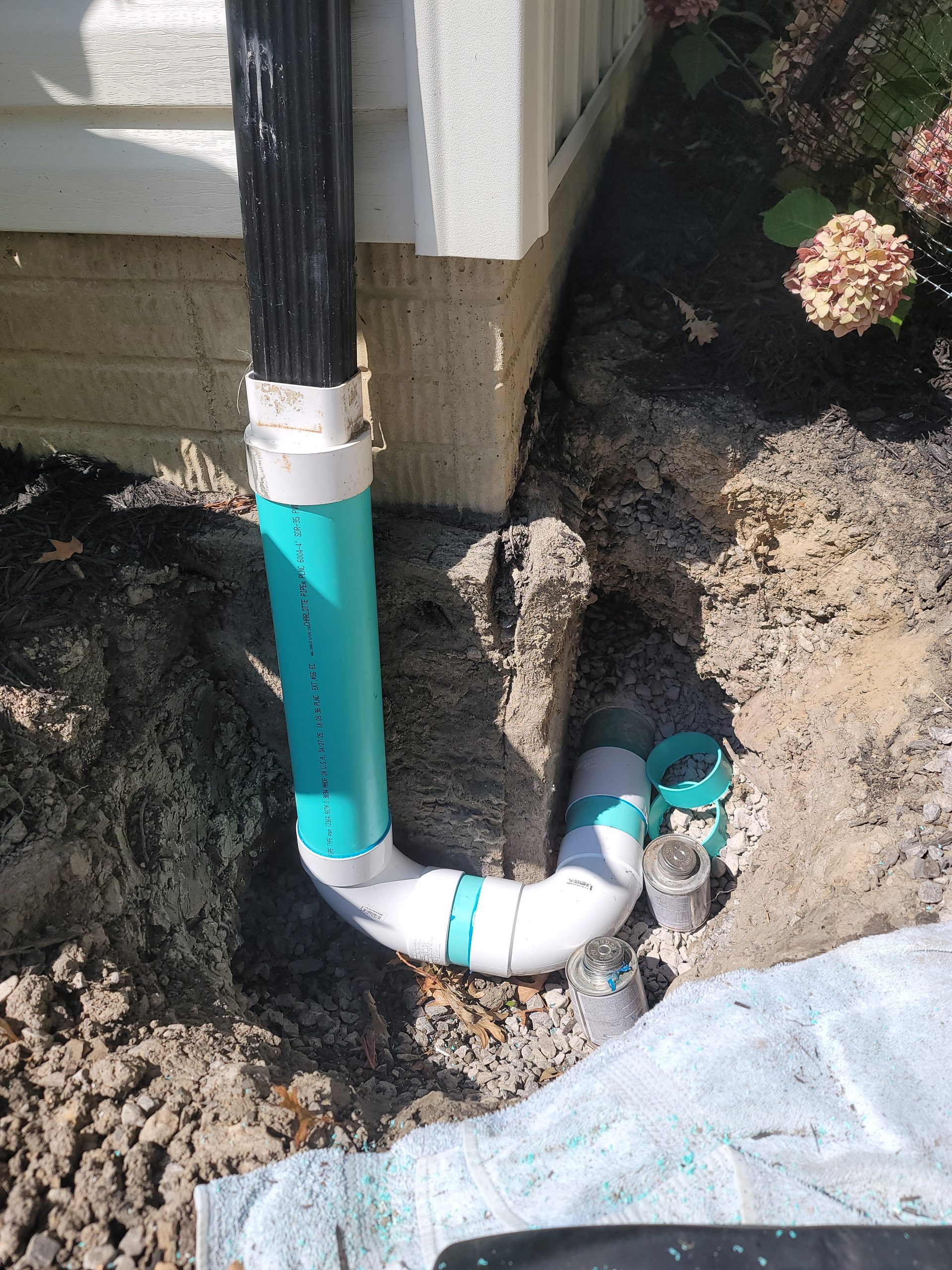 New SDR-35 PVC sewer line installation at a residential foundation by Critical Plumbing, replacing a failed line