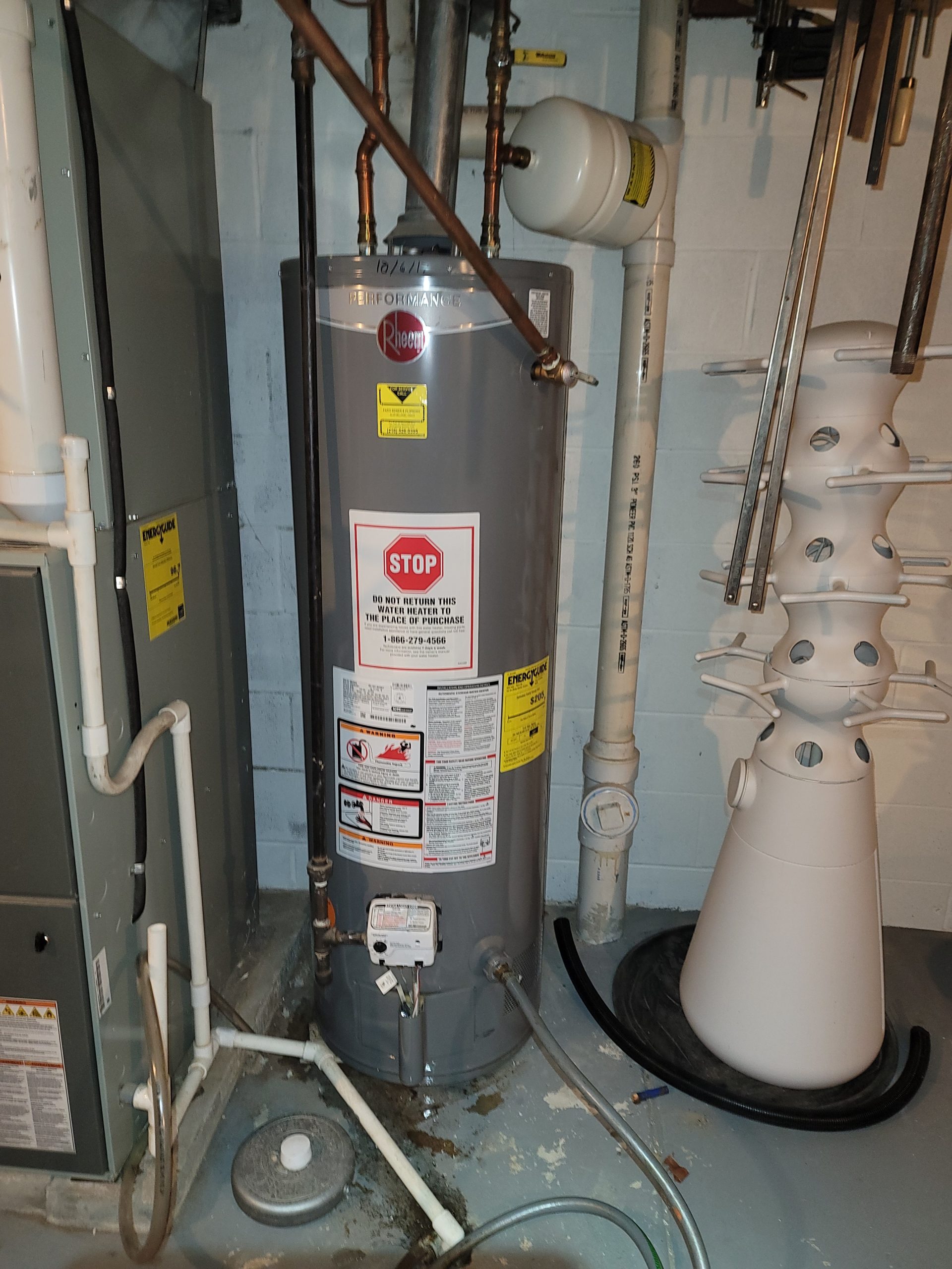 Older Rheem Performance gas water heater near end of service life, before replacement by Critical Plumbing