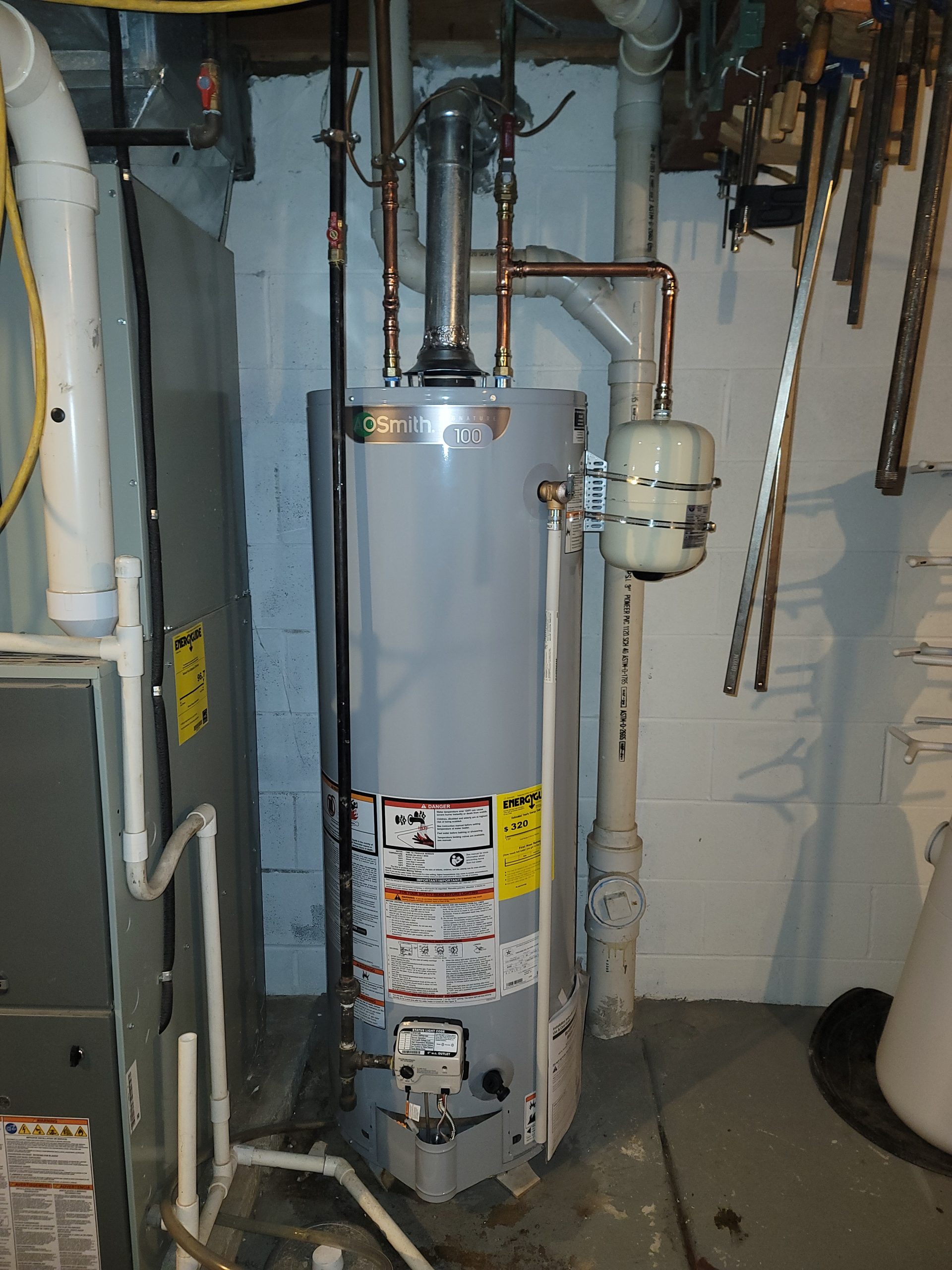 New A.O. Smith Signature 100 gas water heater installation by Critical Plumbing, with code-compliant copper piping and new expansion tank